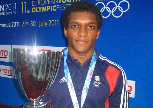 NUMBER ONE: Gymnast Courtney Tulloch was given the flag for the closing ceremony after his two golds, including the prestigous all-round title