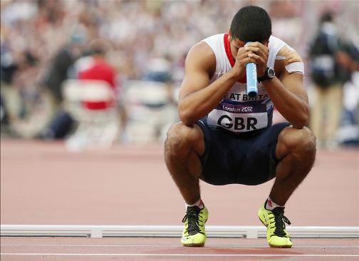 OUT: Adam Gemili looks despondent as Team GB are disqualified in the 4x100m semi-final for exchanging the baton outside the changing zone and running out of their lane