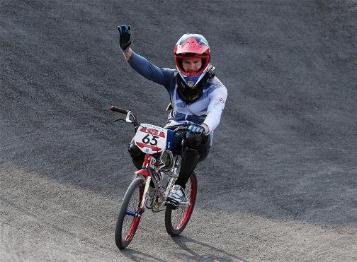 CRASH LANDING: Team GB's Liam Phillips waves to the fans after crashing out of the men's BMX final