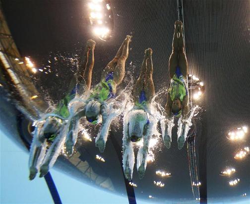 MAKING A SPLASH: Team GB's women's synchronised swimming team dive into the pool to begin their routine