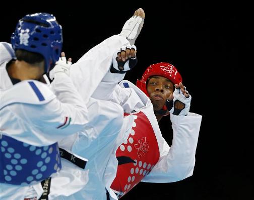 GOOD START: Lutalo Muhammad is into the taekwondo quarter-finals of the 80kg class after victory against Farkhod Negmatov