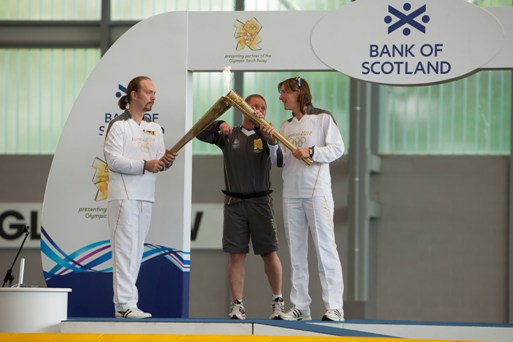 PASS IT ON: Katherine Grainger gets her chance to take off with the Olympic Torch and in turn helps inspire a host of children in attendance in Glasgow